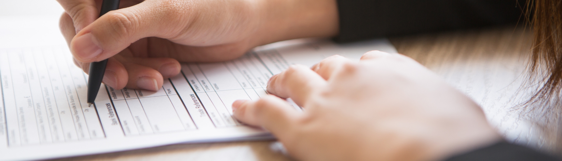hand filling out on paper